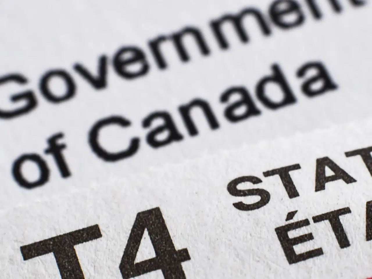 A close-up photo of Canadian tax forms, showing partial text including Government of Canada and T4 STAT in both English and French.