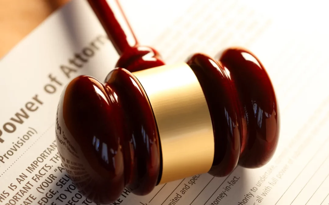 A wooden judge’s gavel rests on a legal document titled Power of Attorney, symbolizing legal authority and decision-making.