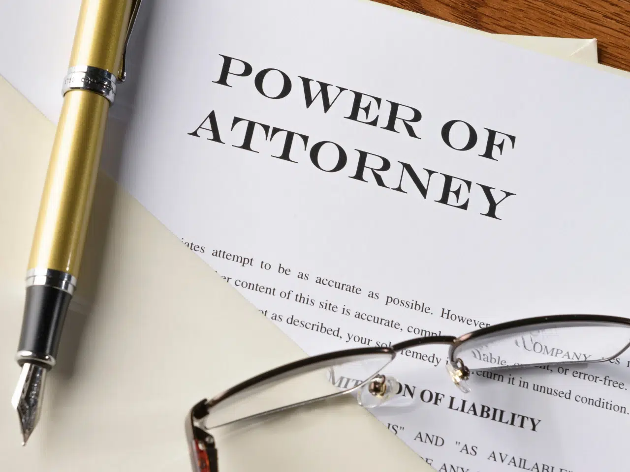 A document titled “Power of Attorney” is partially visible on a desk, with a fountain pen and eyeglasses resting on top of it.