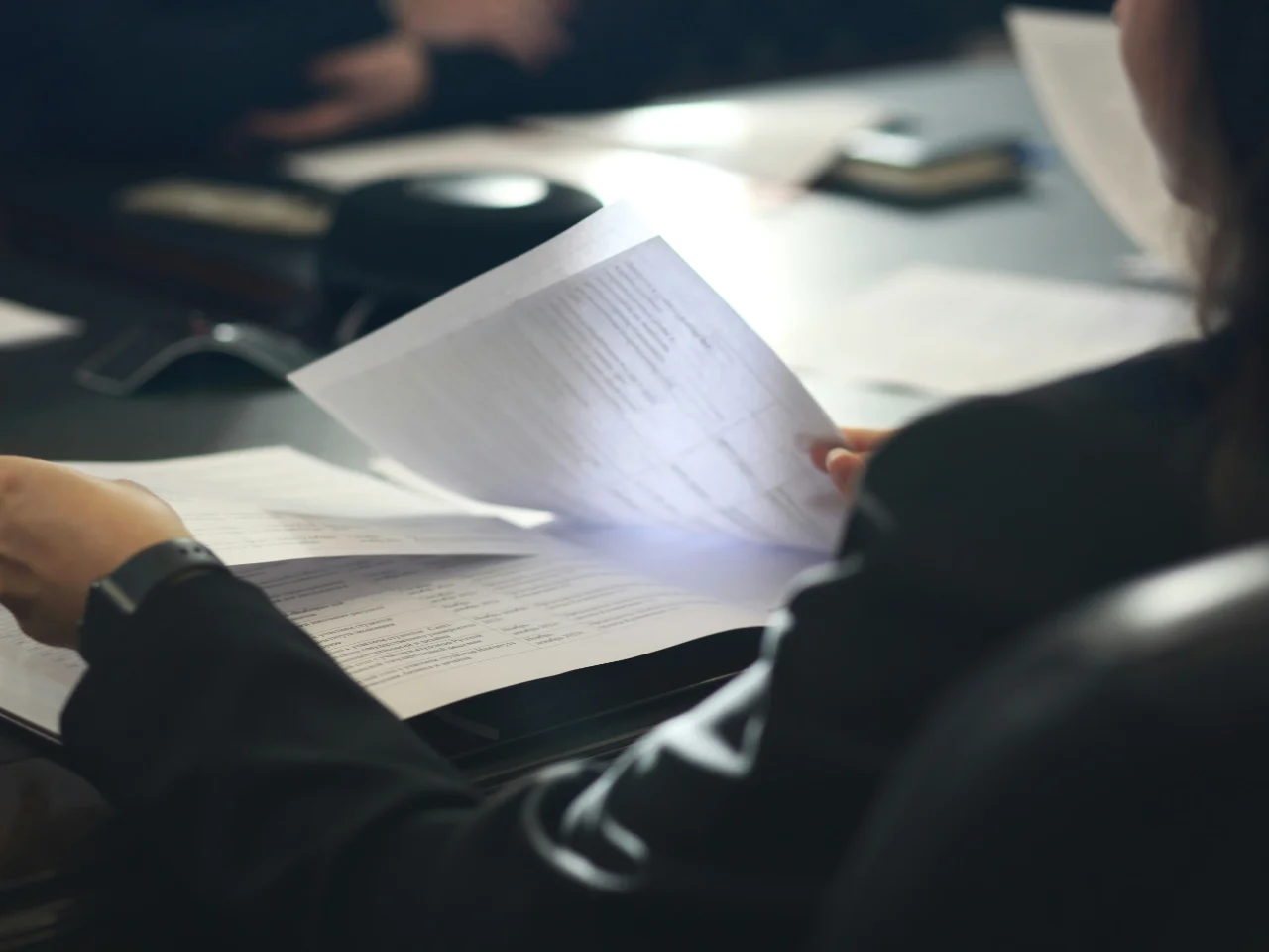 An applicant reviewing documents before applying for a police information check