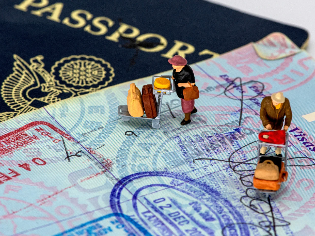 Miniature figures on a stamped passport page